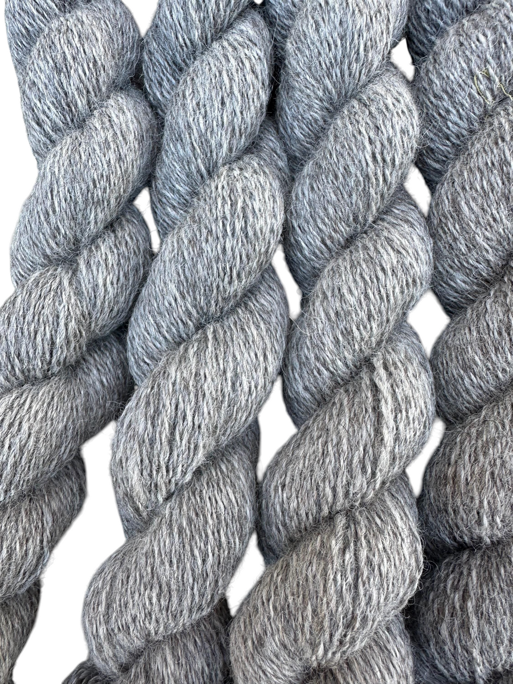 Oak Crest Alpacas and More medium silver gray fingering weight alpaca yarn skein with a soft, dehaired texture.
