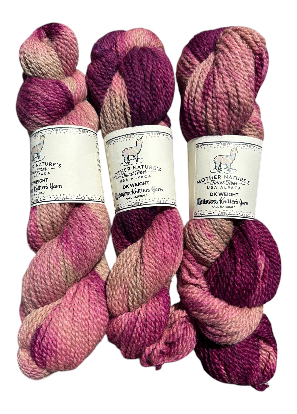 Oak Crest Alpacas and More variegated pink and purple DK weight alpaca merino yarn skeins with product labels