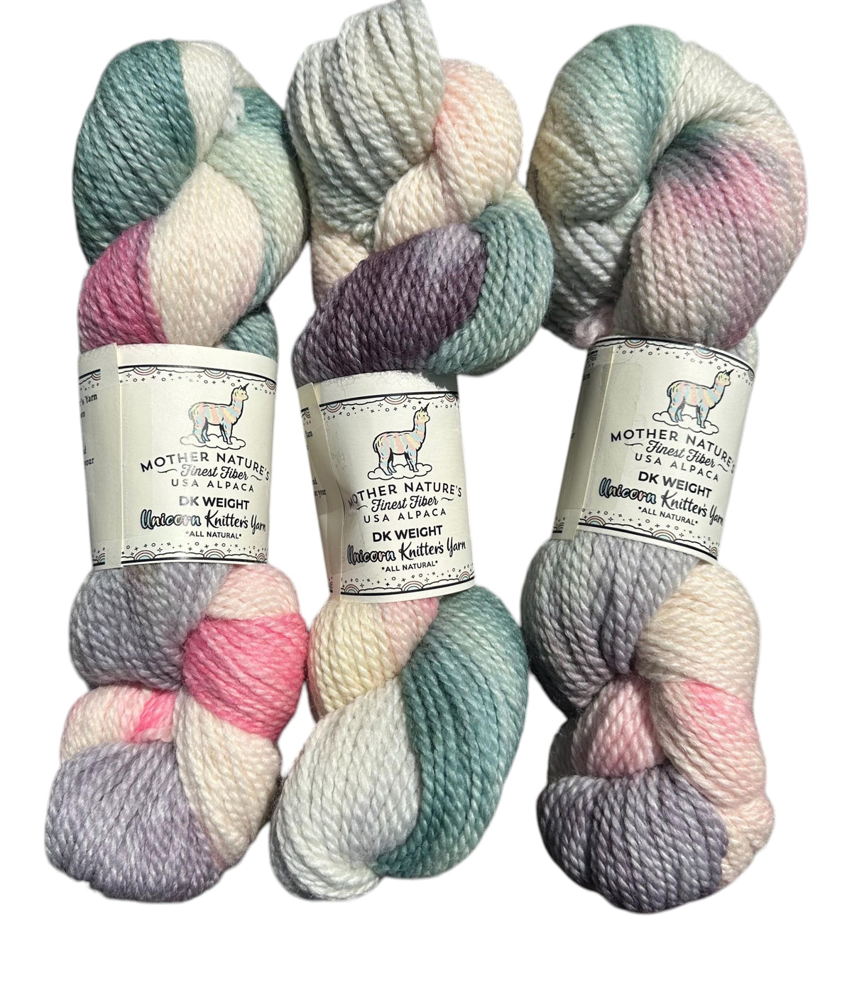 Oak Crest Alpacas and More variegated DK weight yarn skeins in soft pastel pink, green, and grey alpaca merino wool.