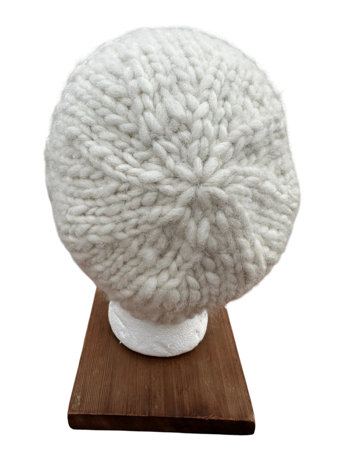Oak Crest Alpacas and More white hand-knit chunky 100% alpaca wool hat viewed from the top on a display stand.