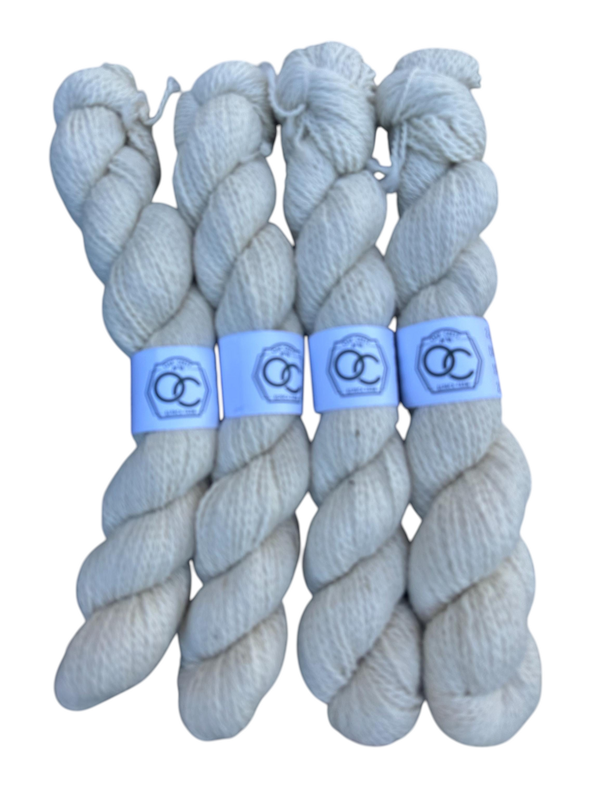 Oak Crest Alpacas and More white natural 2-ply DK alpaca yarn skeins, dehaired for softness.